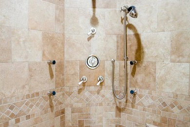 This is an example of a mid-sized traditional 3/4 bathroom in Chicago with a corner shower, beige tile, travertine and beige walls.
