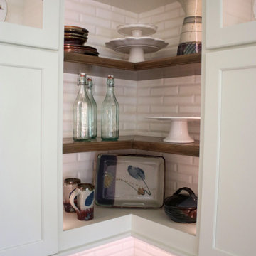 White Kitchen with Gray Quartz Countertops, Farmhouse Sink and Hardwood Floors