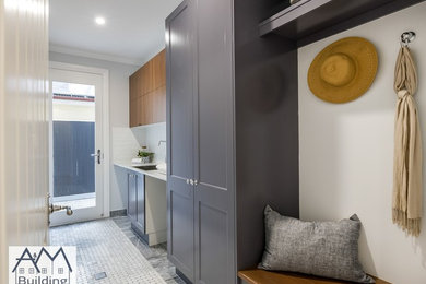 Mid-sized transitional galley utility room in Brisbane with a drop-in sink, shaker cabinets, blue cabinets, marble benchtops, grey walls, marble floors, a side-by-side washer and dryer, grey floor and grey benchtop.