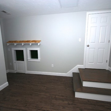 Basement with kids play house under the stairs