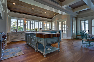 Inspiration for a large farmhouse l-shaped medium tone wood floor and brown floor open concept kitchen remodel in Other with an island, an undermount sink, recessed-panel cabinets, white cabinets, quartzite countertops, window backsplash, paneled appliances and white countertops