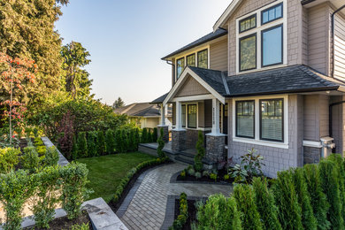 Example of a country home design design in Vancouver