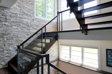 Inspiration for a large contemporary wooden u-shaped open staircase remodel in Toronto