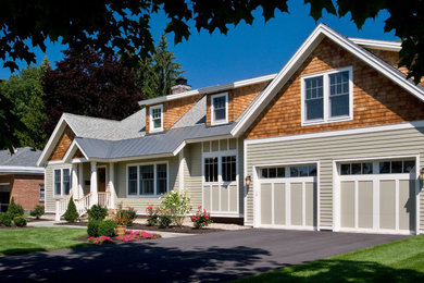 Photo of a mid-sized traditional two-storey beige house exterior in Boston with mixed siding and a gable roof.