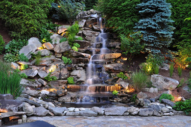 Photo of a country garden in Charlotte with a water feature.