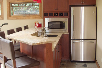 Inspiration for a mid-sized modern l-shaped kitchen remodel in Detroit with an undermount sink, shaker cabinets, dark wood cabinets and granite countertops