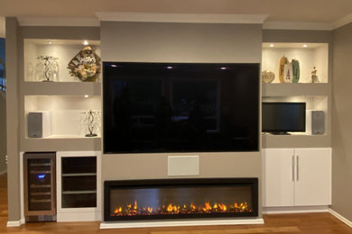 Example of a mid-sized trendy medium tone wood floor living room design in Seattle with brown walls and a standard fireplace