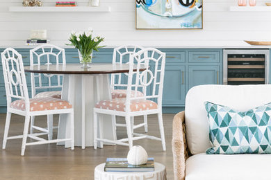 Beach style medium tone wood floor and brown floor dining room photo in Charleston with white walls