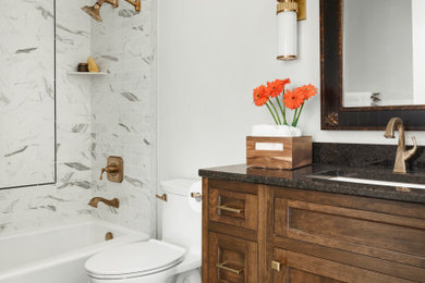 Example of a transitional porcelain tile, black floor and single-sink bathroom design in Minneapolis with recessed-panel cabinets, dark wood cabinets, gray walls, an undermount sink, quartzite countertops, black countertops and a built-in vanity