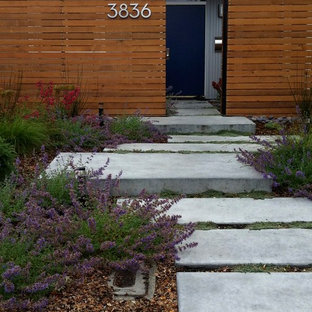 Aménagement d'un jardin avant rétro avec des pavés en béton.