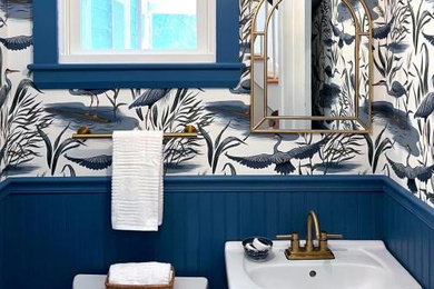 Example of a small trendy marble floor and wallpaper powder room design in Boston with black cabinets and a freestanding vanity