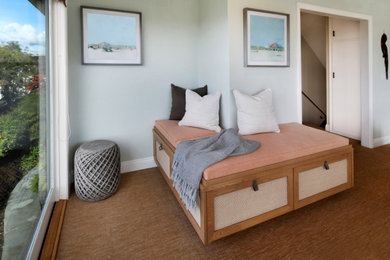 Mid-sized beach style enclosed carpeted, brown floor and wallpaper family room library photo in Orange County with blue walls, a standard fireplace and a wall-mounted tv