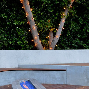 Custom Cement Fire Pit in Mangaris Wood Deck. LED's light up Mangaris Lounge and