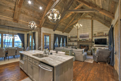 Inspiration for a mid-sized cottage open concept dark wood floor, brown floor, vaulted ceiling and wood wall family room remodel in Atlanta with white walls, a standard fireplace and a stone fireplace