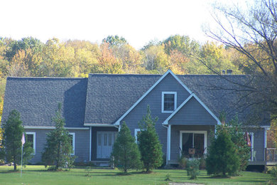 Mid-sized farmhouse gray two-story wood exterior home photo in Cleveland