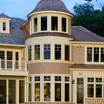 Lake Side Elevation of Cape Cod Stone and Shingle Style House Featuring Turret