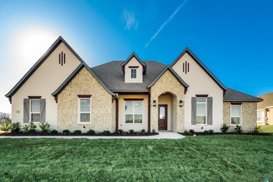 Mid-sized french country white one-story brick exterior home idea in Dallas with a shingle roof