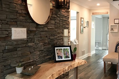 Entryway - mid-sized transitional dark wood floor and black floor entryway idea in Toronto with gray walls and a glass front door