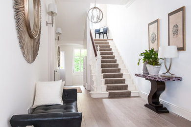Inspiration for a contemporary hallway in Other with white walls and light hardwood floors.