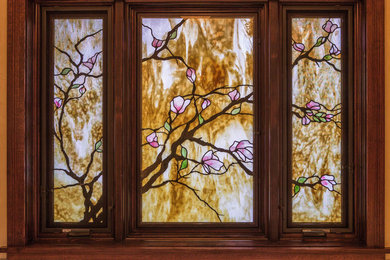 Inspiration for a transitional kitchen remodel in Denver with glass-front cabinets and dark wood cabinets