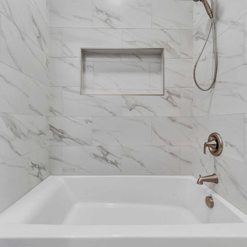 Marble-Look Shower with Built-In Niche and Brushed Nickel Fixtures