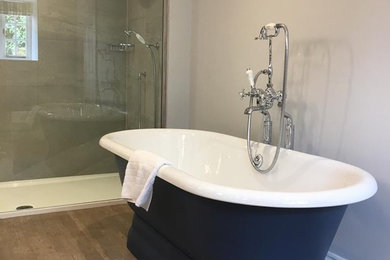 This is an example of a large rural ensuite bathroom in Gloucestershire with blue cabinets.