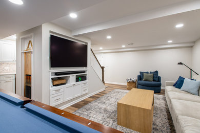 Inspiration for a mid-sized transitional look-out vinyl floor and brown floor basement remodel in Chicago with a bar and white walls