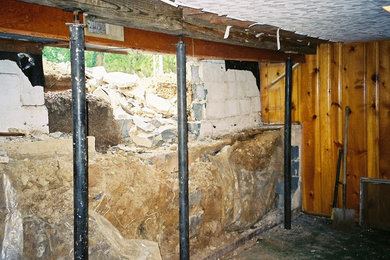 Inspiration for an underground concrete floor and gray floor basement remodel in Other with multicolored walls