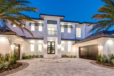 Huge transitional white two-story house exterior photo in Miami with a tile roof