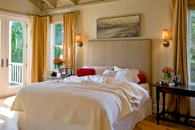 Inspiration for a bedroom in San Francisco with beige walls, medium hardwood floors and yellow floor.