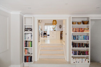 Design ideas for a medium sized bohemian kitchen/dining room in London with beige walls, a standard fireplace, a stone fireplace surround and white floors.