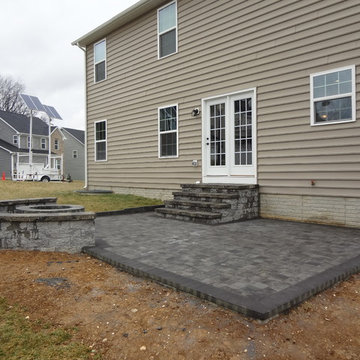 Paver Patio with outdoor fire pit and seating wall along with steps.