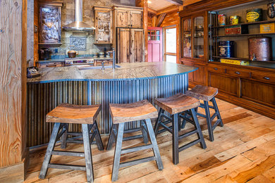 Open concept kitchen - large rustic light wood floor and brown floor open concept kitchen idea in Denver with a farmhouse sink, shaker cabinets, light wood cabinets, beige backsplash, stone tile backsplash, paneled appliances and an island