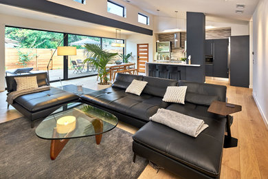 Inspiration for a small contemporary l-shaped light wood floor open concept kitchen remodel in San Francisco with an undermount sink, flat-panel cabinets, blue cabinets, quartz countertops, gray backsplash, ceramic backsplash, stainless steel appliances and an island