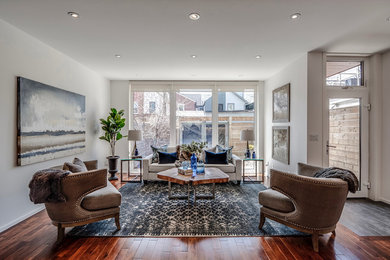 Photo of a mid-sized contemporary formal open concept living room in Toronto with white walls, dark hardwood floors, no fireplace, no tv and brown floor.