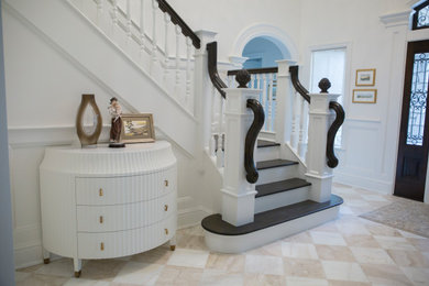 Example of a large ornate wooden u-shaped wood railing and wood wall staircase design in New York with wooden risers