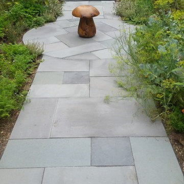 An extensive landscape project with stonewalls, patio, dry river bed & more