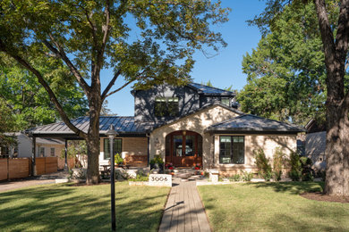 Inspiration for a transitional blue two-story stone house exterior remodel in Austin with a metal roof and a black roof