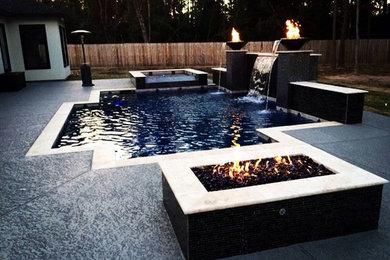 Inspiration for a mid-sized contemporary backyard concrete and custom-shaped lap pool fountain remodel in Houston