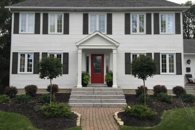 Example of a classic white two-story exterior home design in Ottawa