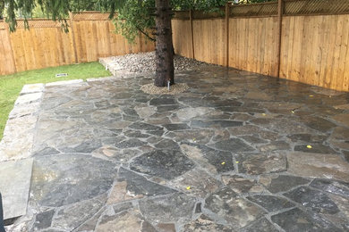 Large minimalist backyard stamped concrete patio photo in Toronto with no cover