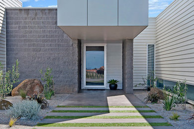 This is an example of a large modern front door in Melbourne with white walls, concrete floors, a single front door and a white front door.