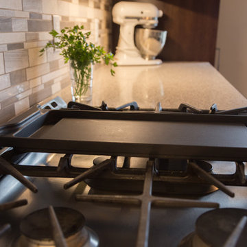 Falsetta - Brown Cabinets with Mosaic Tile Backsplash