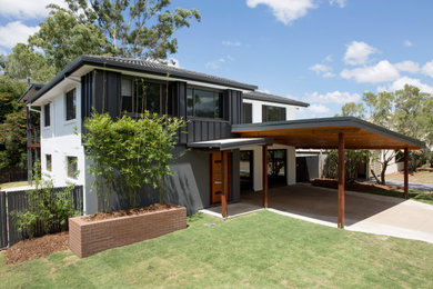 Modern two-storey grey house exterior in Brisbane with a hip roof and a black roof.