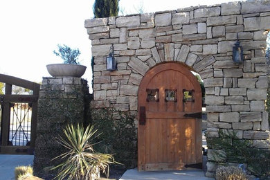Example of a tuscan stone exterior home design in Other