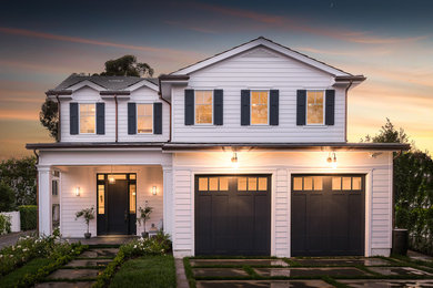 Large elegant white three-story concrete fiberboard gable roof photo in Los Angeles