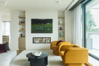 Photo of a contemporary open concept living room in Melbourne with a plaster fireplace surround, a wall-mounted tv and multi-coloured floor.