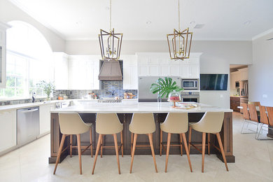 Example of a large transitional u-shaped porcelain tile and white floor eat-in kitchen design in Other with a farmhouse sink, flat-panel cabinets, white cabinets, marble countertops, multicolored backsplash, ceramic backsplash, stainless steel appliances, an island and white countertops