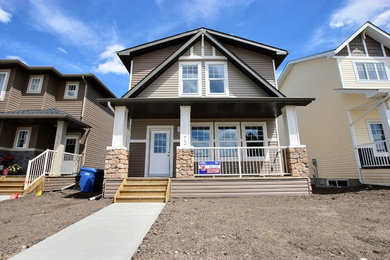 Inspiration for a mid-sized craftsman brown two-story vinyl gable roof remodel in Toronto