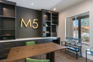 Inspiration for a mid-sized contemporary freestanding desk medium tone wood floor and brown floor study room remodel in Phoenix with gray walls